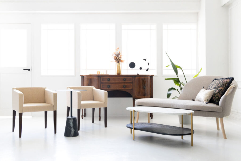 白基調の自然光あふれる明るいスペースに家具が並んだ写真
